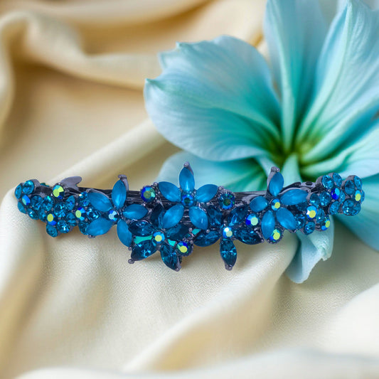 : Haerime FleurVerre Cascade Barrette in Blue Zircon – multicolor floral crystal hair barrette shown on ivory satin, studio-lit for natural brilliance