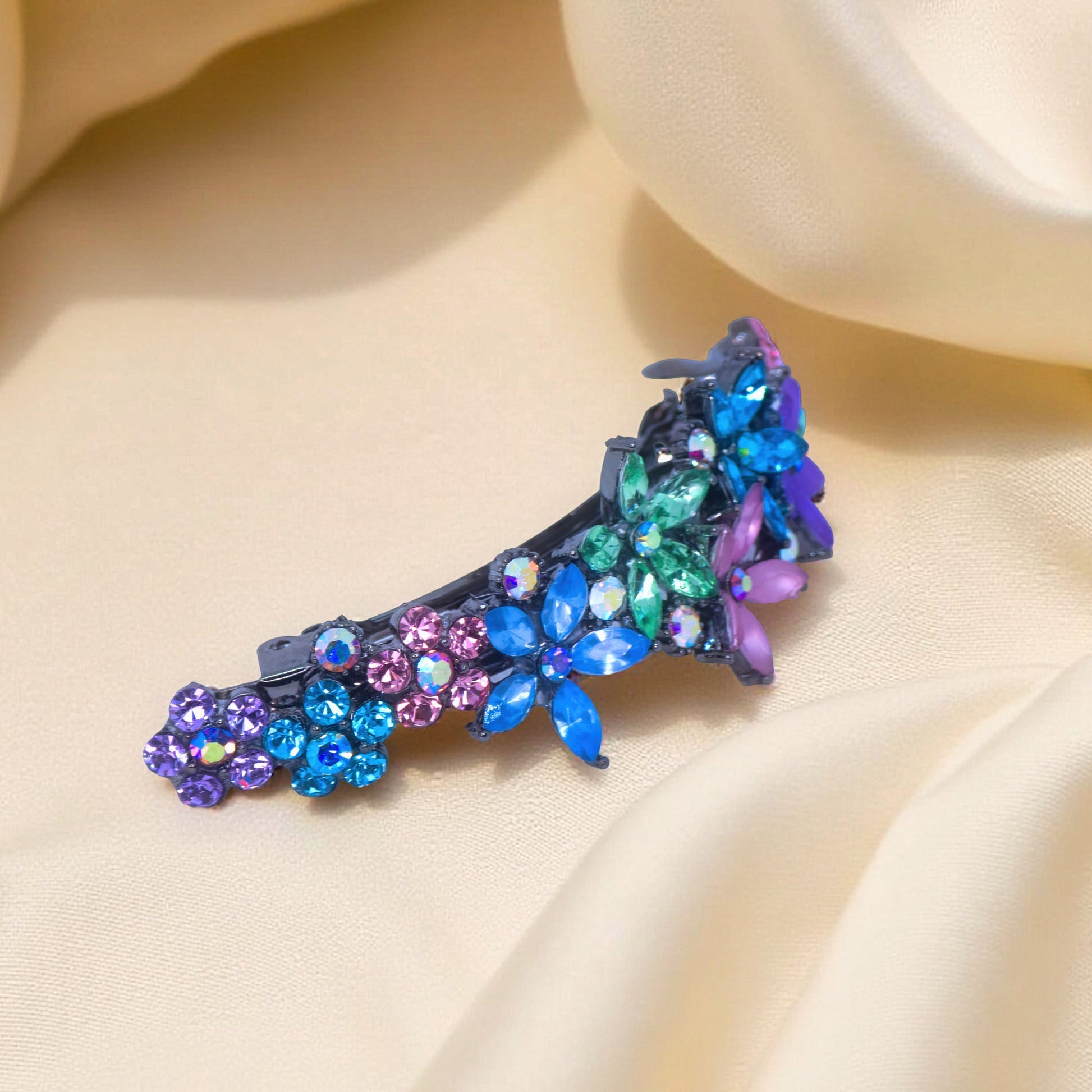: Side view of Haerime FleurVerre Cascade Barrette in Rainbow – arched silhouette with floral structure and antique silver stem