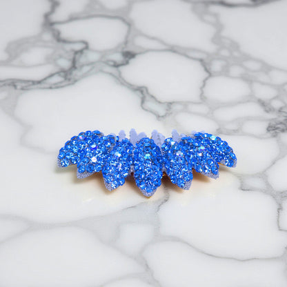 Haerime Gleamleaf Crown Comb in Blue – side vertical view showing arc shape and faceted petals