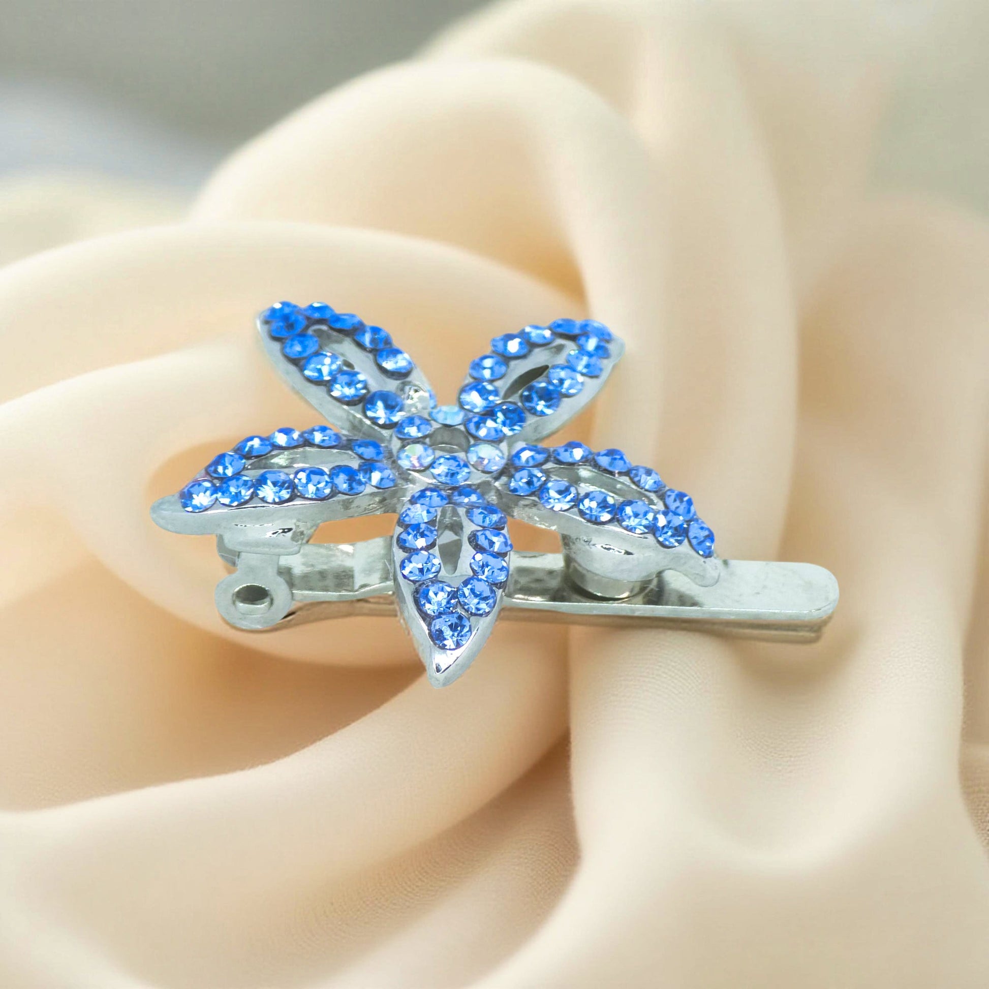 Haerime LilyGleam Clip in Blue – angled view highlighting five-petal pavé crystals and open clasp structure