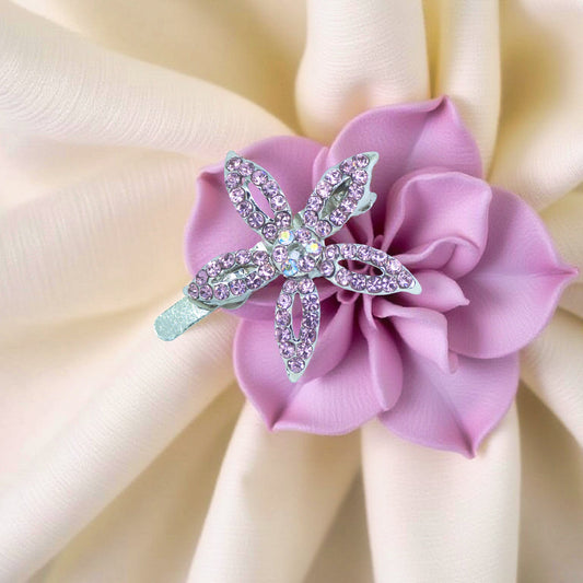 Haerime LilyGleam Clip in Purple – main image showing five-petal crystal bloom on velvet pouch with soft fabric folds