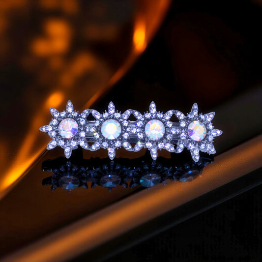 Haerime Luna Halo Barrette in Clear – front view of aurora-cut crystal starburst clip with black-plated base on velvet background