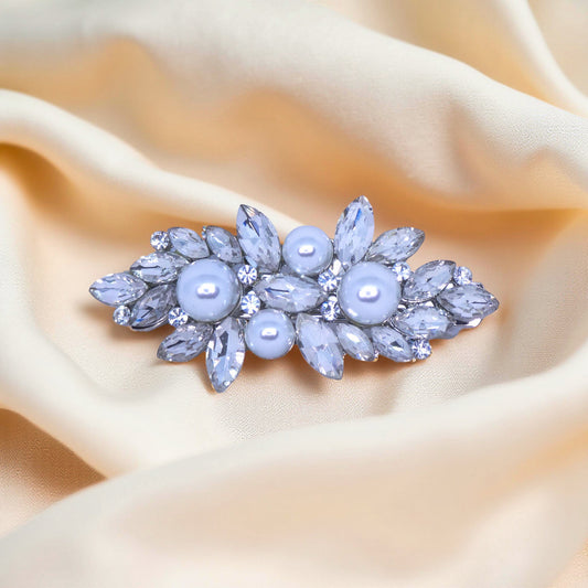 Haerime Lunaria Petite Barrette in Pearl – front view of silver leaf barrette with pearl center and marquise crystal halo on velvet pouch