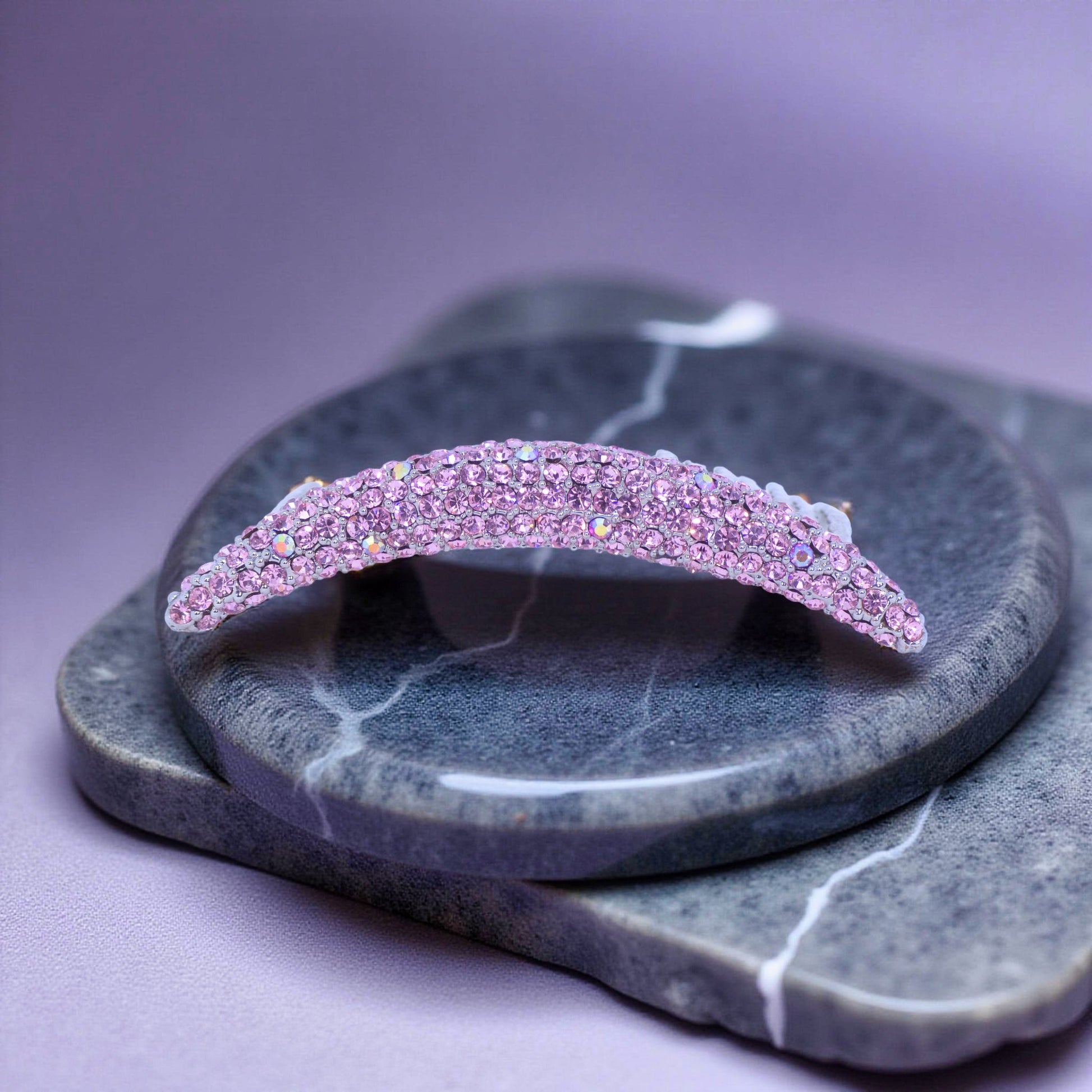 Haerime Lunoria Arch Comb in Pink – close-up showing rose-hued crystals along curved body on soft blush background