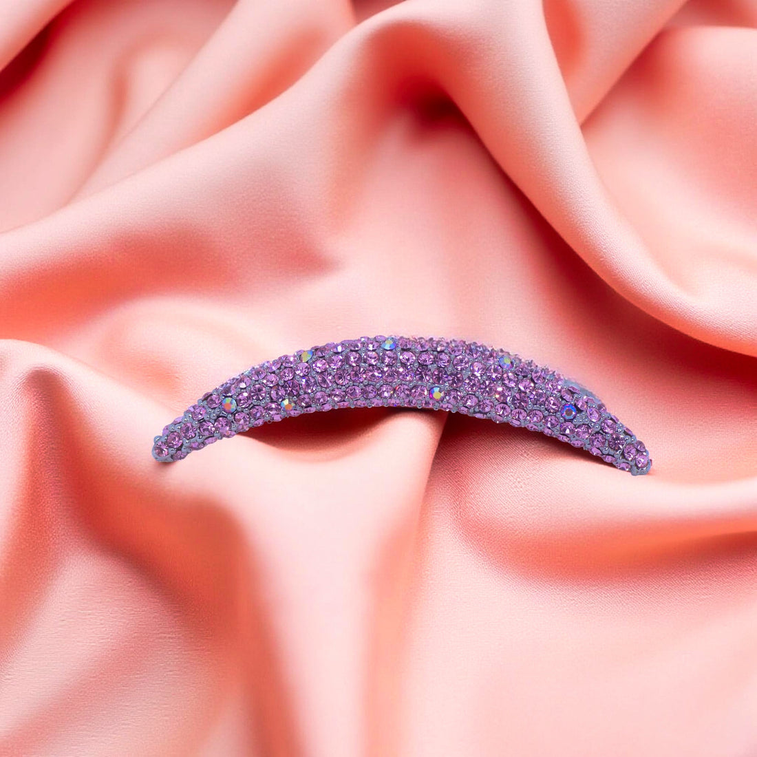 Haerime Lunoria Arch Comb in Pink – flat lay of pink floral-inspired comb on pale velvet pouch