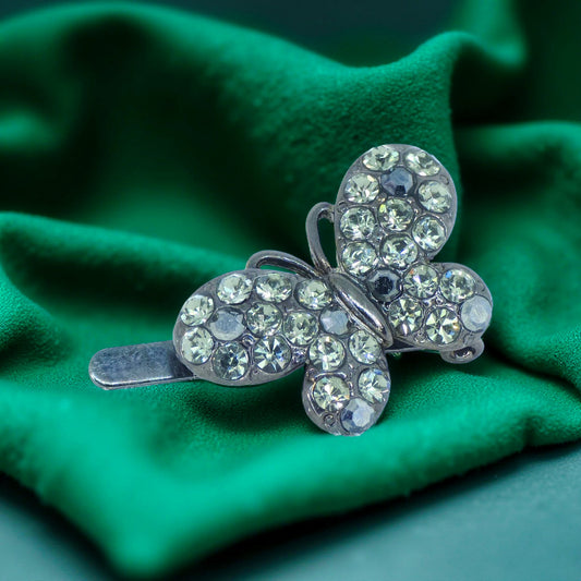  Haerime Papillon Éclat Clip in Black – pavé crystal butterfly silhouette shown on dark velvet surface, emphasizing sculptural symmetry