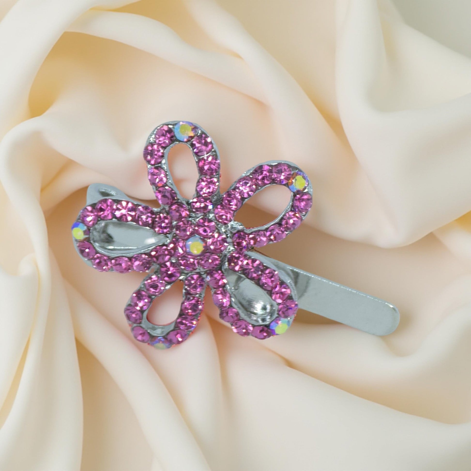 Haerime PetalMuse Magnetique in Pink – soft rose pavé mini bloom clip resting on folded ivory satin background