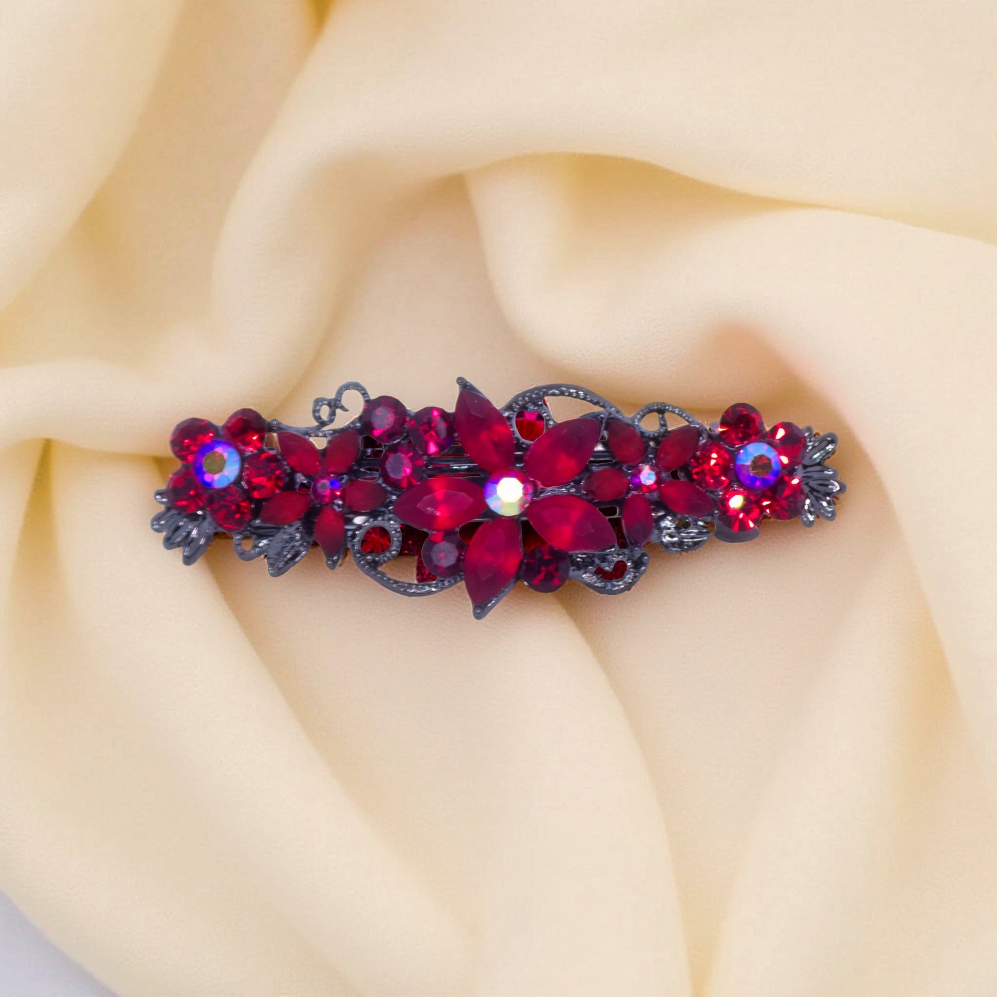 Haerime Serenbelle Bloom in Red – close-up showing garnet and ruby marquise petals atop warm velvet surface in soft ambient light