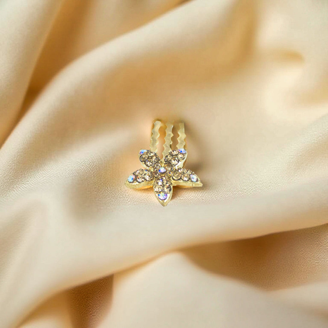 Haerime Starpetal Minis in Amber – honey pavé crystal petals placed on beige velvet in soft directional light