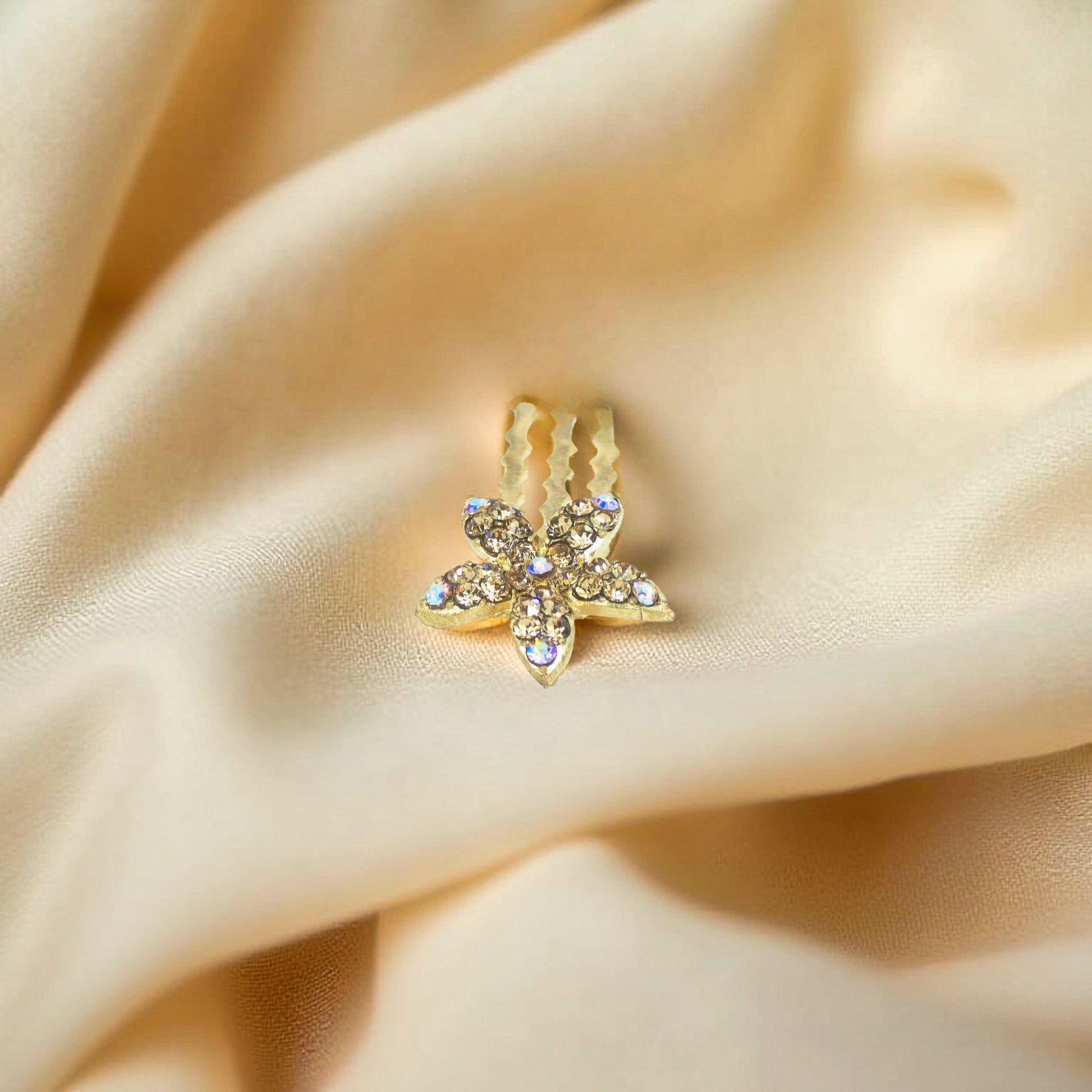 Haerime Starpetal Minis in Amber – honey pavé crystal petals placed on beige velvet in soft directional light