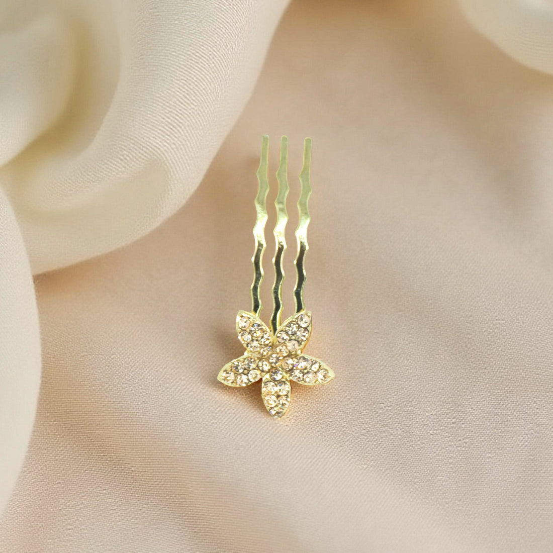  Haerime Starpetal Minis in Amber – golden yellow flower pin with faceted crystals resting on warm satin folds