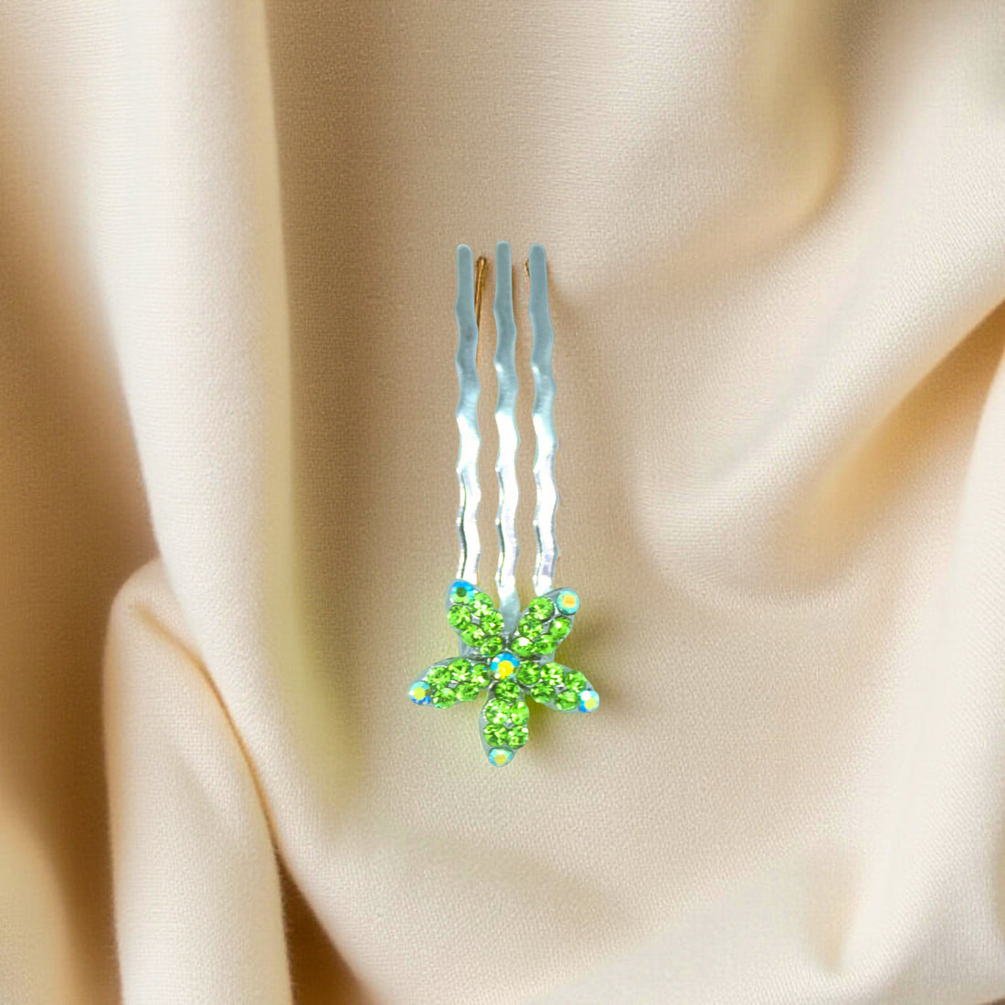 Haerime Starpetal Minis in Peridot – lime green mini crystal flower placed on matte ivory satin with soft light reflections
