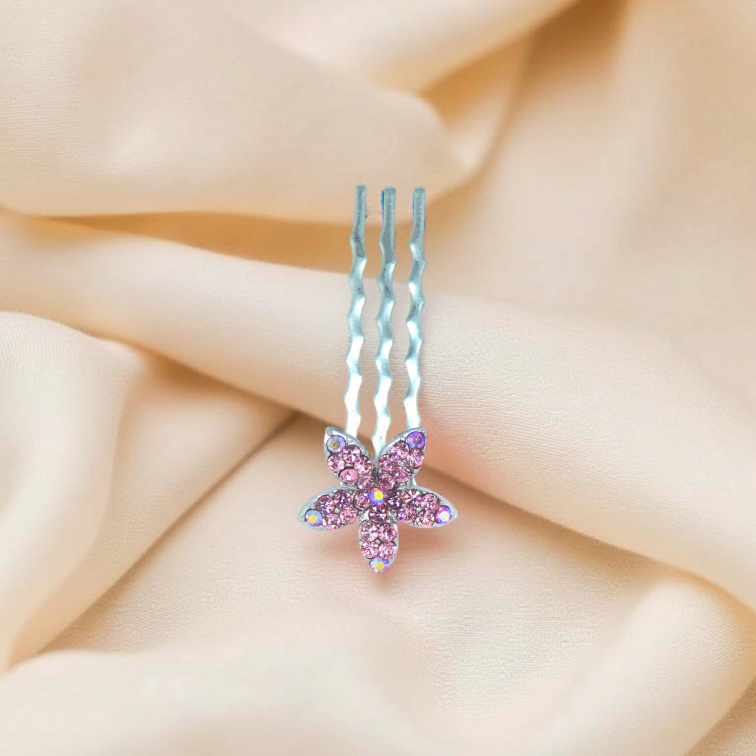 Haerime Starpetal Minis in Pink – macro of pastel pink pavé petals on gold-prong comb against ivory silk