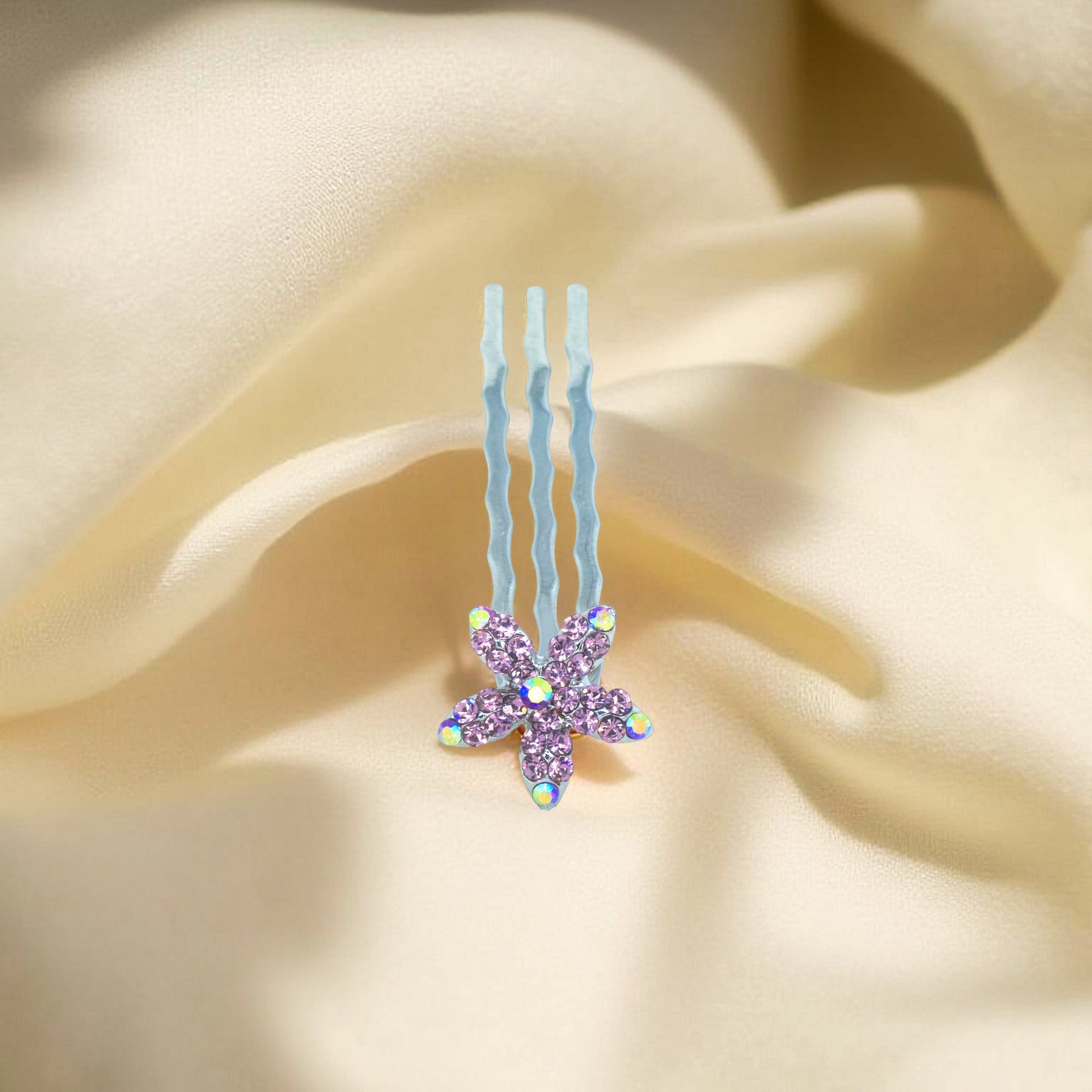Haerime Starpetal Minis in Purple – close-up of lilac crystal flower pin centered on champagne-toned silk background