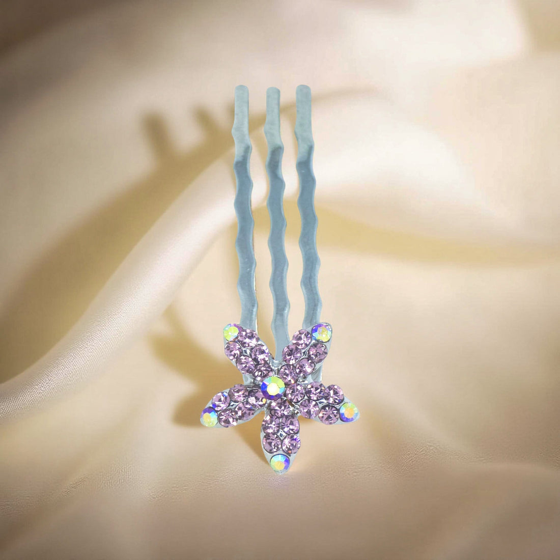 Haerime Starpetal Minis in Purple – violet five-petal mini comb resting on soft ivory satin with gentle gradient shadows