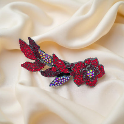 Haerime Twilight Bloom Mini in Red – angled floral hair accessory resting on matte rose-toned background with botanical depth