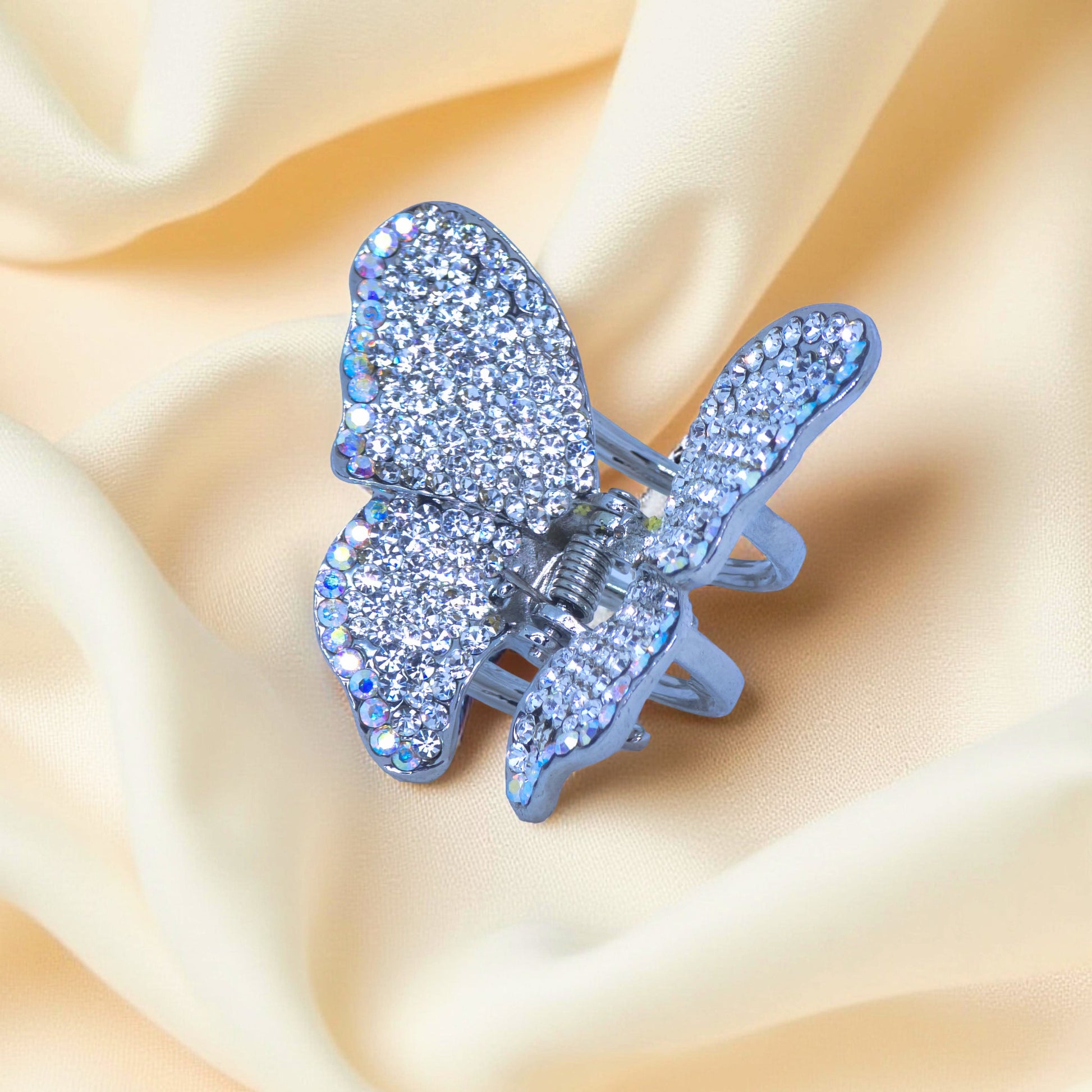 Haerime Papillora Mini Claw in Clear – macro view of shimmering white crystals over satin drape with light diffusion